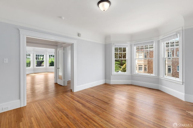unfurnished room featuring wood finished floors and baseboards