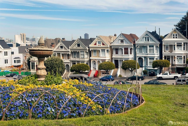 view of community featuring a lawn and a residential view