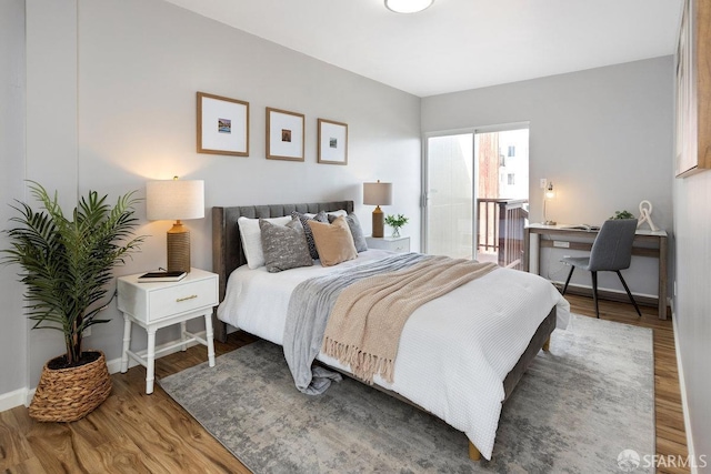 bedroom featuring baseboards and wood finished floors