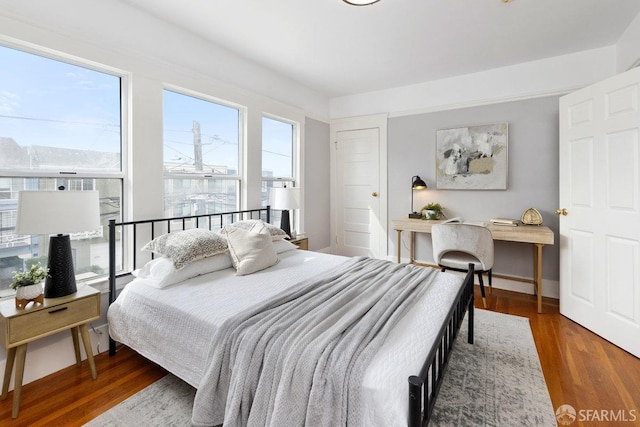 bedroom featuring baseboards and wood finished floors