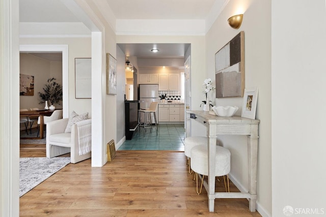 interior space featuring light wood finished floors and baseboards