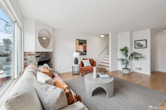 75 Lurline St, San Francisco, CA 94122 - living room featuring wood finished floors, stairs, a fireplace, and baseboards