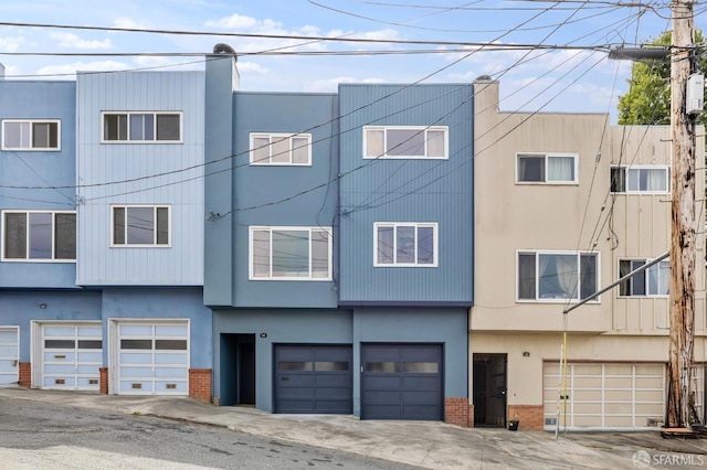 75 Lurline St, San Francisco, CA 94122 - view of front of home featuring brick siding, an attached garage, and stucco siding