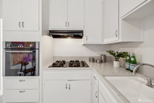 75 Lurline St, San Francisco, CA 94122 - kitchen with oven, gas cooktop, under cabinet range hood, light countertops, and a sink