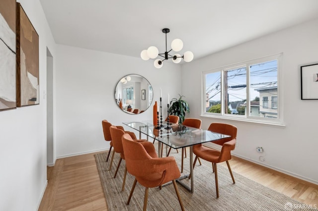 75 Lurline St, San Francisco, CA 94122 - dining area featuring light wood finished floors, baseboards, and a chandelier