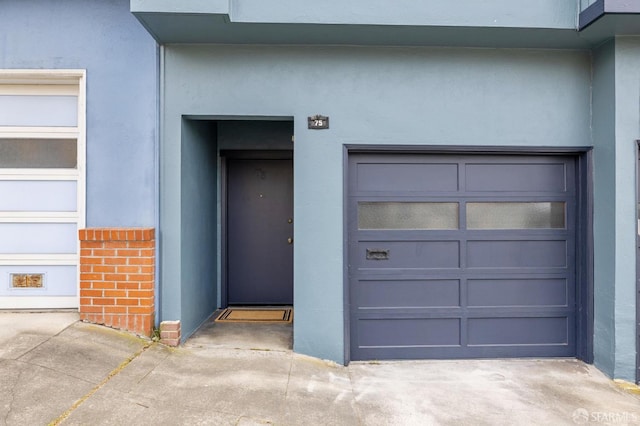 75 Lurline St, San Francisco, CA 94122 - doorway to property with stucco siding and a garage