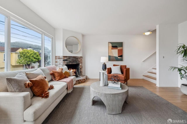 75 Lurline St, San Francisco, CA 94122 - living room featuring wood finished floors, stairs, a brick fireplace, and baseboards