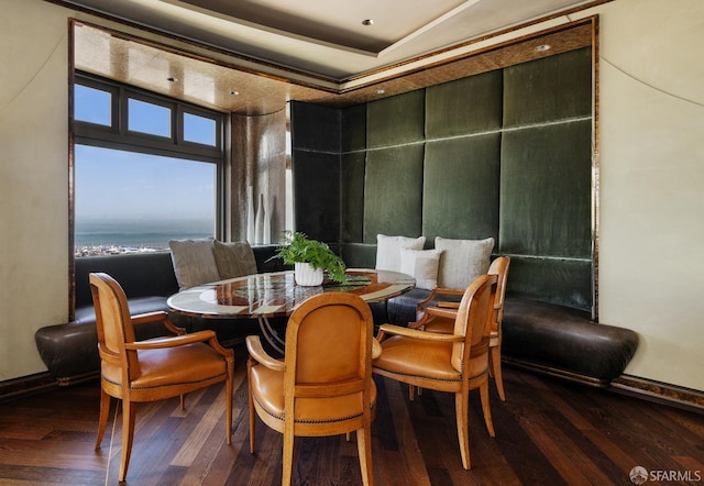 dining room featuring wood finished floors and baseboards