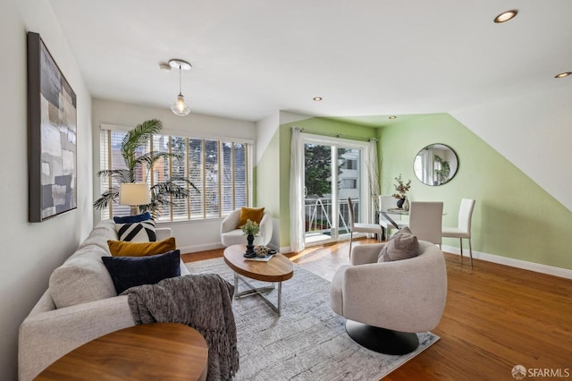 living area with vaulted ceiling, recessed lighting, baseboards, and wood finished floors