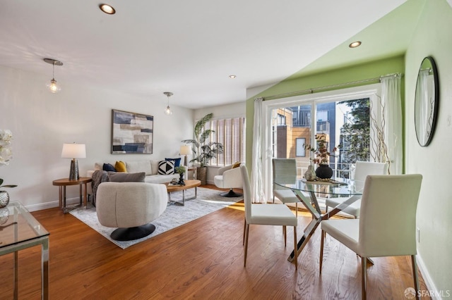 dining room with recessed lighting, a healthy amount of sunlight, and wood finished floors