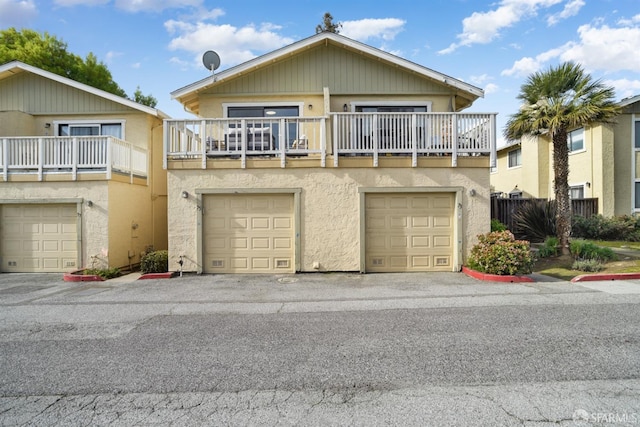 view of property featuring a garage and stucco siding