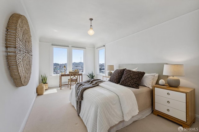 bedroom with baseboards and light colored carpet