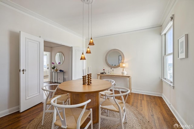 dining room with dark wood-style floors, ornamental molding, and baseboards