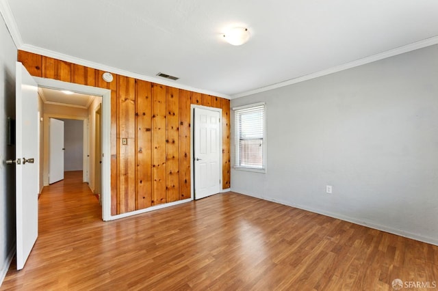 1220 Mesa St, Concord, CA 94518 - empty room featuring ornamental molding, light wood finished floors, and wood walls