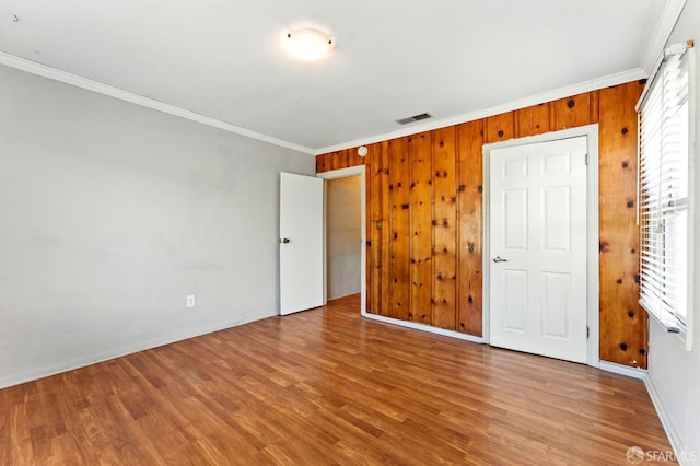 1220 Mesa St, Concord, CA 94518 - unfurnished bedroom with ornamental molding, wood finished floors, and wooden walls