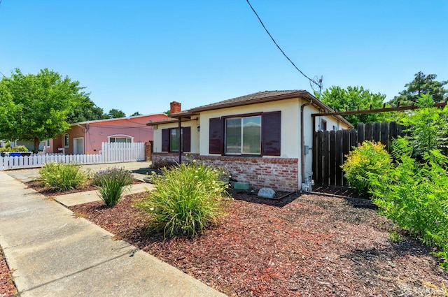 1220 Mesa St, Concord, CA 94518 - view of front of house with a chimney, stucco siding, and brick siding