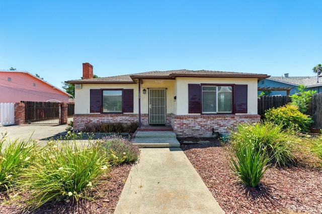1220 Mesa St, Concord, CA 94518 - bungalow with a chimney, stucco siding, a gate, and brick siding