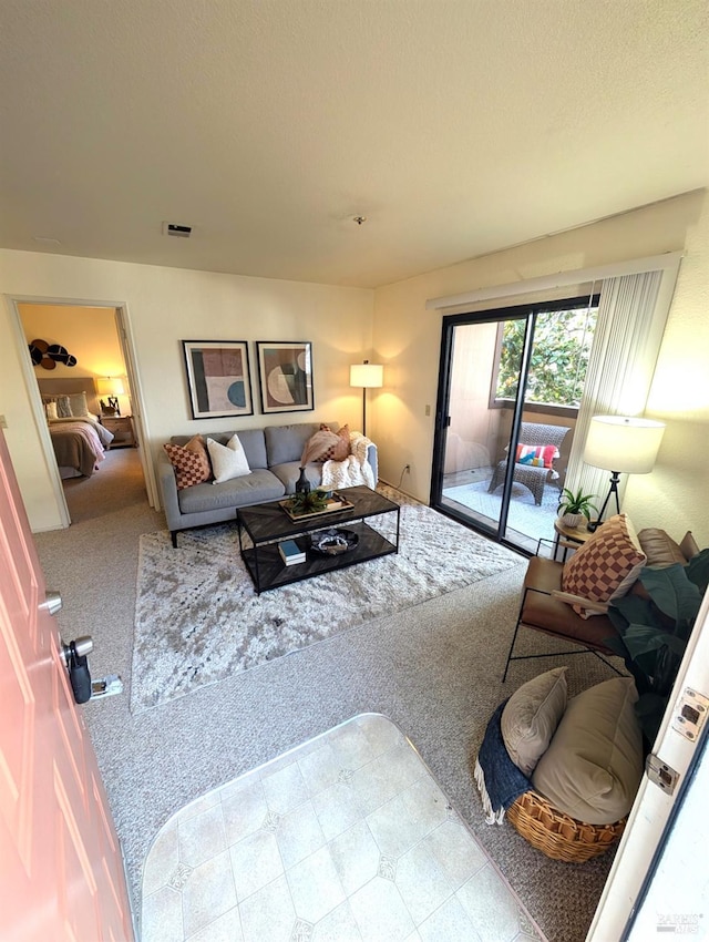 carpeted living room featuring a textured ceiling