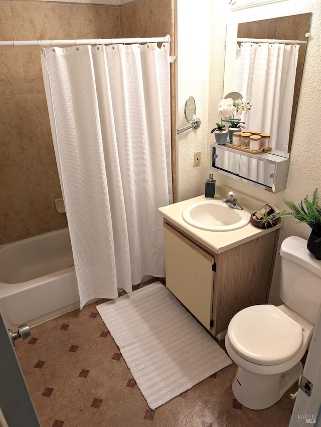 full bathroom with shower / tub combo, vanity, and toilet