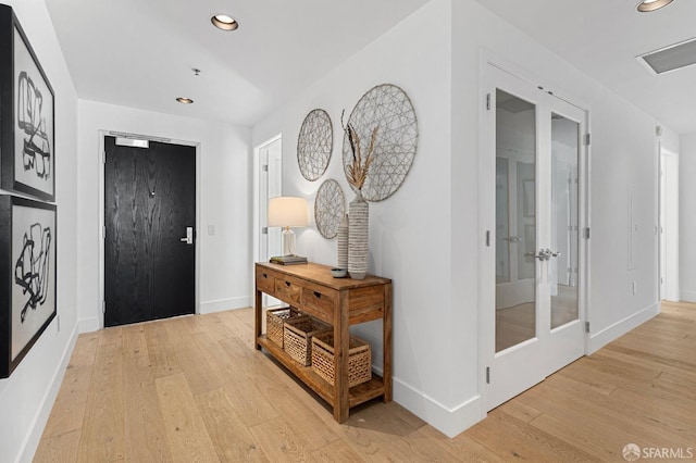 foyer entrance with recessed lighting, french doors, light wood-style flooring, and baseboards