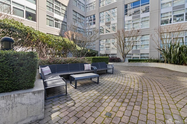 view of community with an outdoor hangout area and a patio