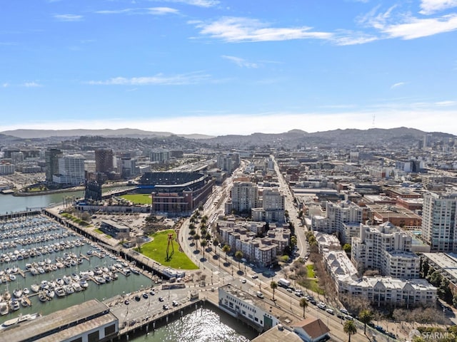 drone / aerial view featuring a water and mountain view and a city view