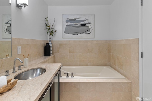 bathroom featuring a garden tub, vanity, and decorative backsplash