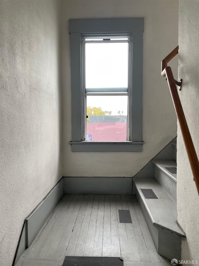 stairs with hardwood / wood-style flooring