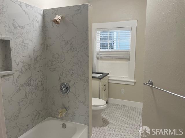 full bathroom with vanity, tiled shower / bath combo, toilet, and tile patterned flooring