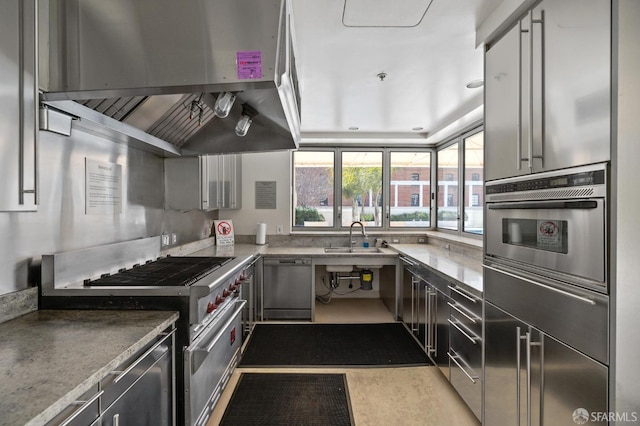 kitchen with appliances with stainless steel finishes, island exhaust hood, sink, vaulted ceiling, and gray cabinetry