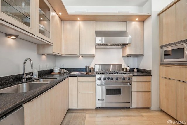 kitchen with sink, light brown cabinets, wall chimney exhaust hood, and stainless steel appliances