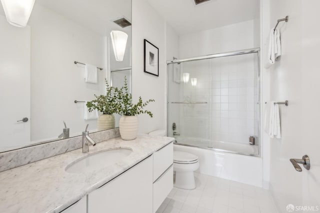 full bathroom featuring vanity, toilet, and combined bath / shower with glass door