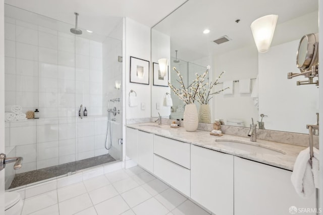 bathroom featuring vanity, tile patterned floors, and a shower with door