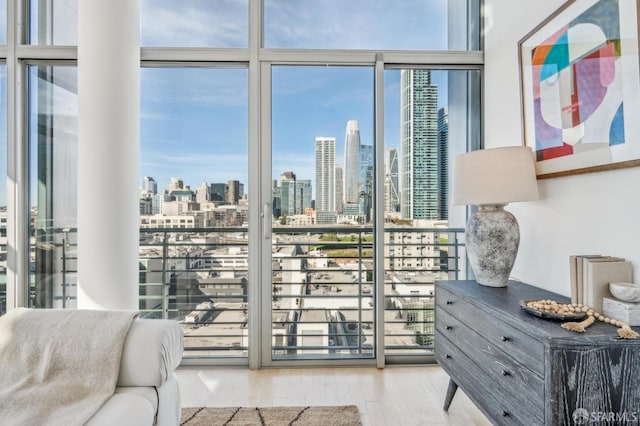 interior space featuring a wall of windows and light hardwood / wood-style floors