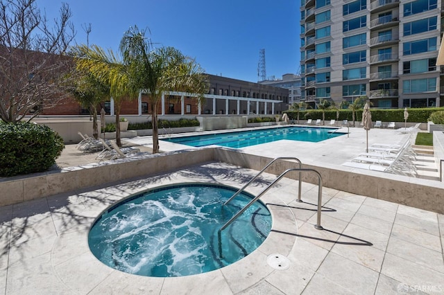 view of pool with a community hot tub and a patio