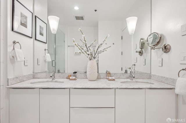 bathroom with walk in shower and vanity