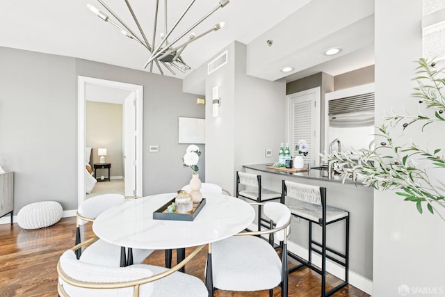 dining space featuring sink and hardwood / wood-style floors