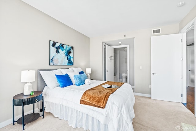 carpeted bedroom with ensuite bathroom