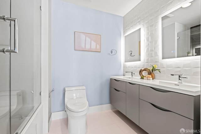 full bathroom with tile patterned floors, toilet, vanity, enclosed tub / shower combo, and decorative backsplash