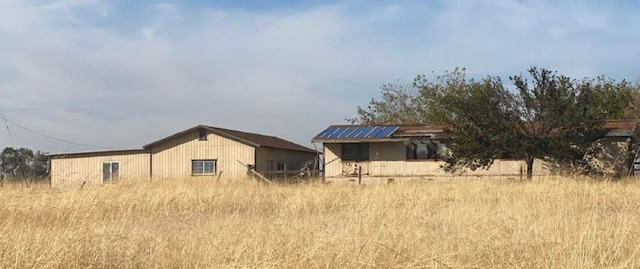 back of house with solar panels