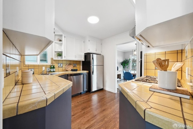 kitchen with tile countertops, dark wood-style floors, white cabinets, stainless steel appliances, and open shelves