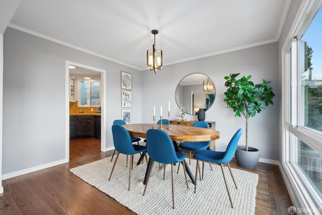 dining area featuring an inviting chandelier, crown molding, dark wood-type flooring, and baseboards