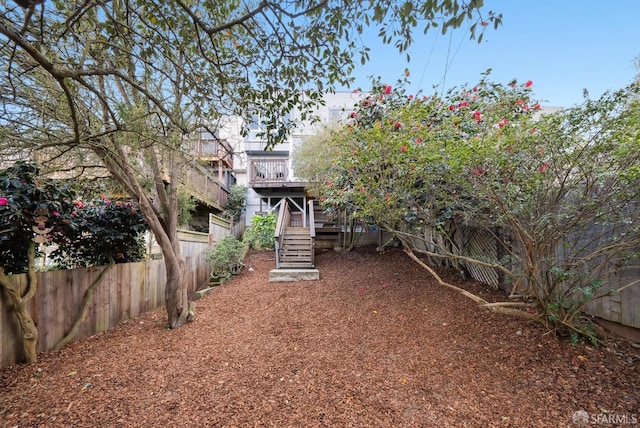 view of yard featuring stairs and fence