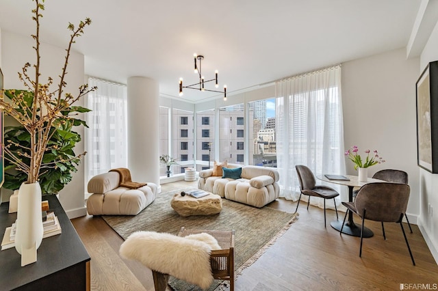 living area featuring a city view, wood finished floors, and a chandelier