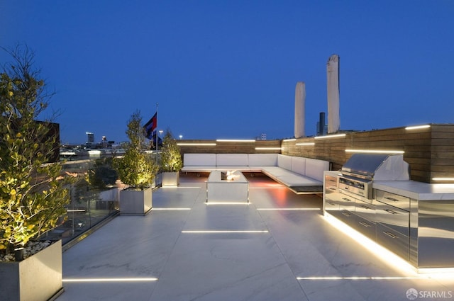 patio at twilight featuring area for grilling and grilling area