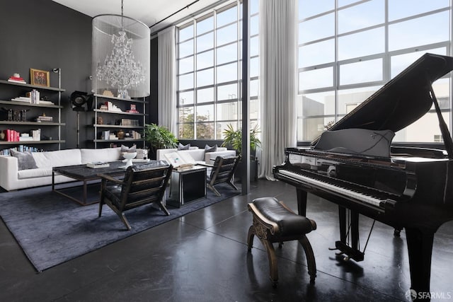 sitting room with a high ceiling, concrete floors, and expansive windows