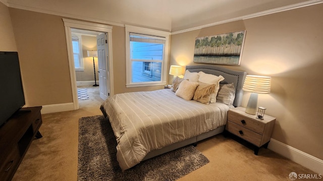 carpeted bedroom featuring ornamental molding and connected bathroom