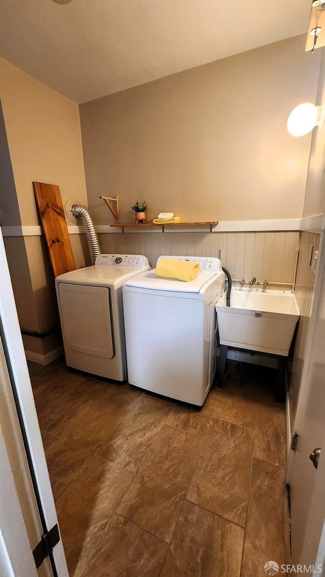 clothes washing area with washer and dryer and sink