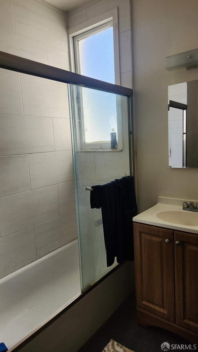 bathroom with vanity and combined bath / shower with glass door