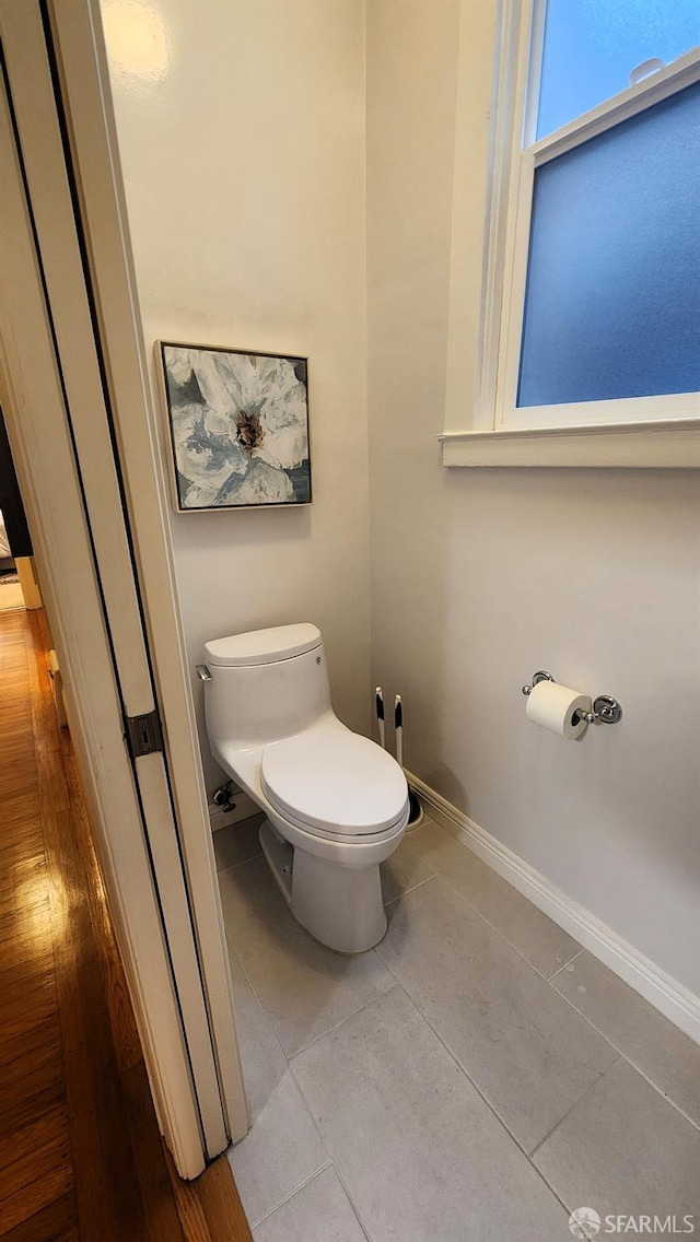 bathroom featuring toilet and tile patterned flooring